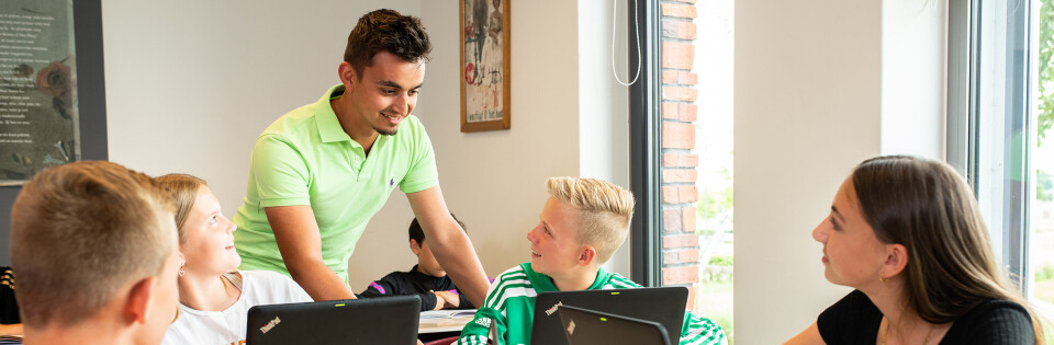 Portus docent legt uit bij laptop